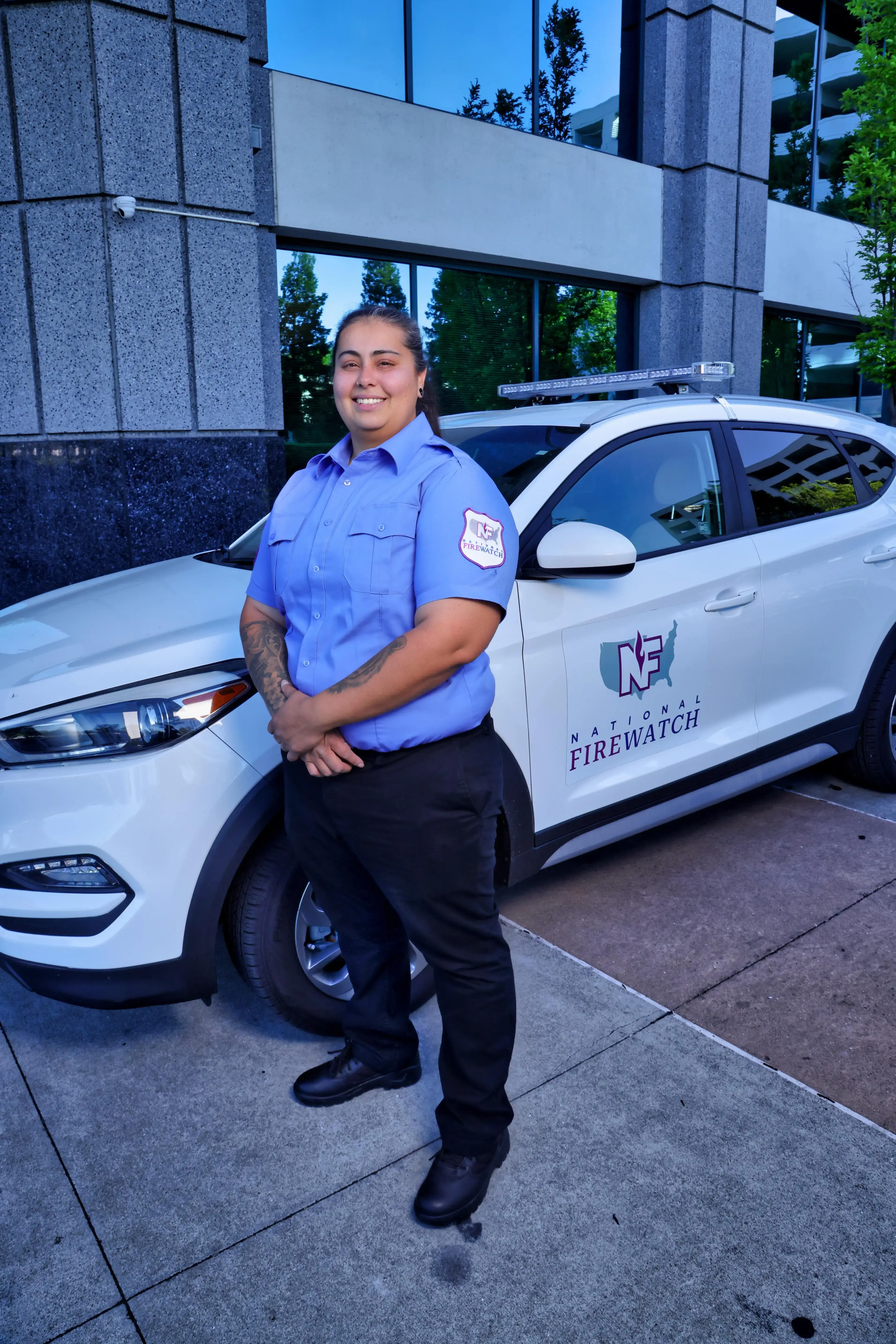 National Firewatch guard in front of company car