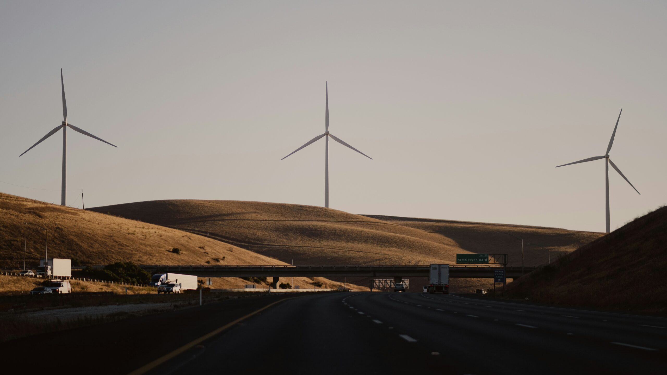 highway in stockton california with hillsides and windmills